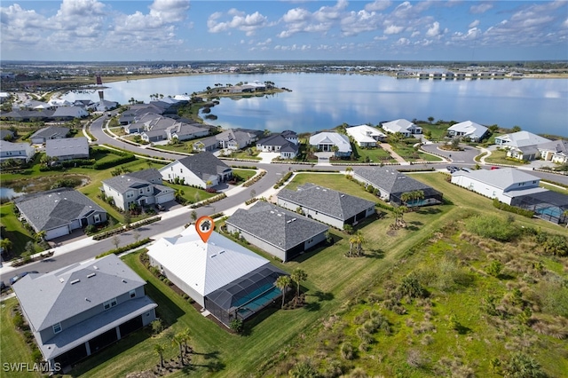 birds eye view of property with a water view