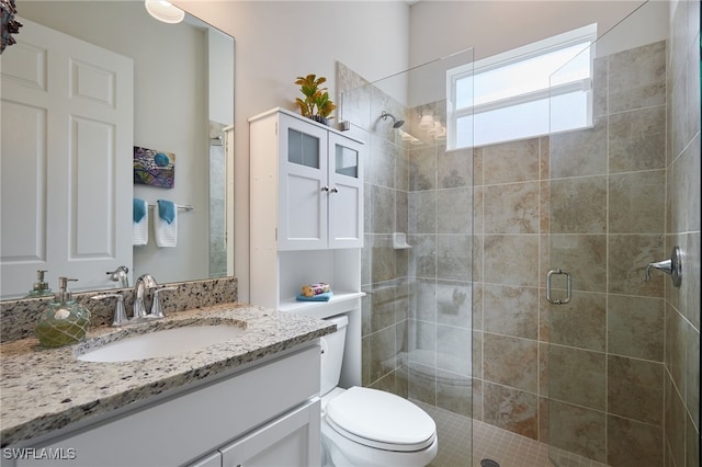 bathroom featuring walk in shower, vanity, and toilet