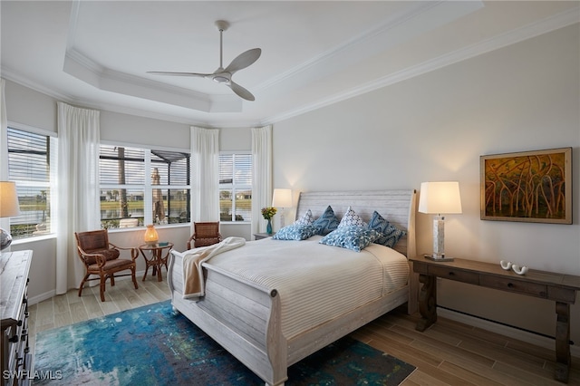 bedroom featuring crown molding, ceiling fan, and a tray ceiling