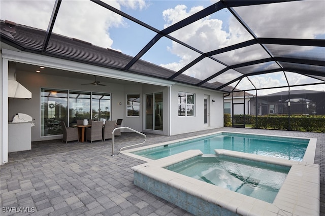 view of swimming pool with an in ground hot tub, glass enclosure, and a patio area