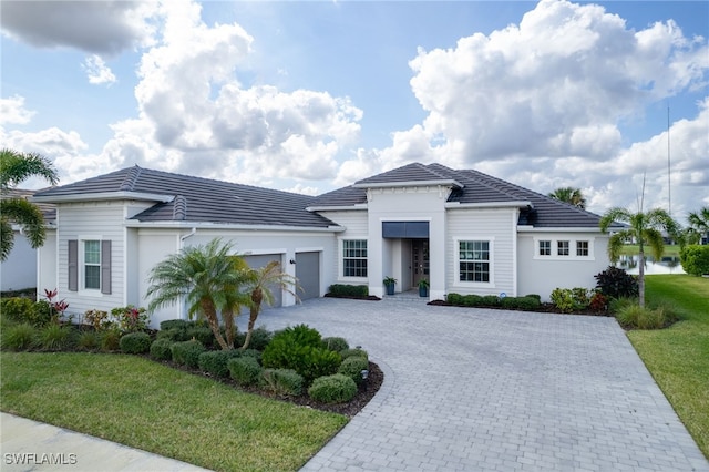 view of front of house with a garage and a front lawn