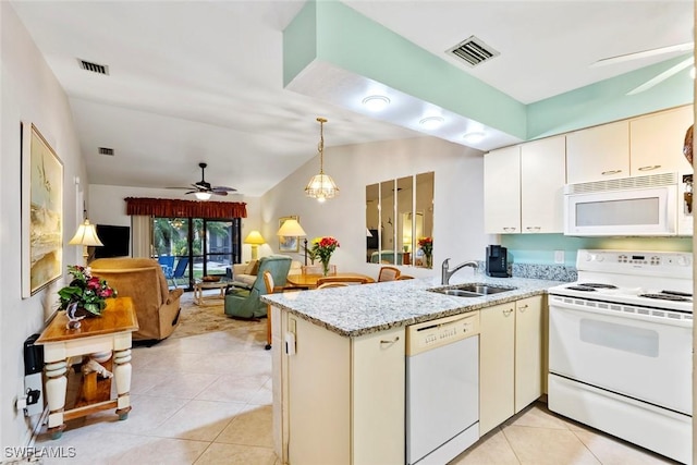 kitchen featuring sink, white appliances, cream cabinets, and light tile patterned floors