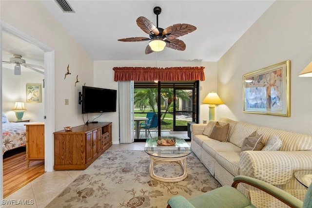 living room with ceiling fan and light tile patterned flooring