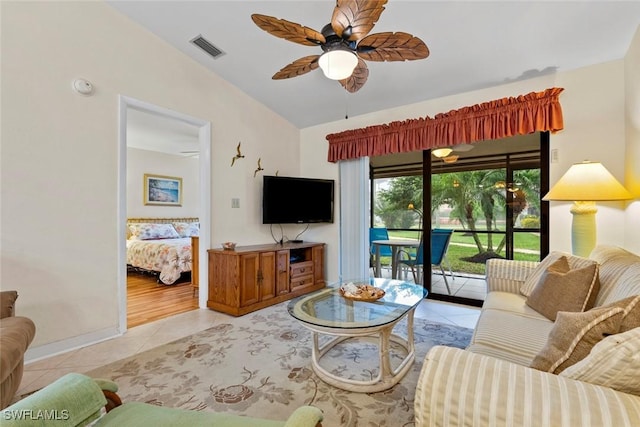 living room with lofted ceiling, light tile patterned floors, and ceiling fan