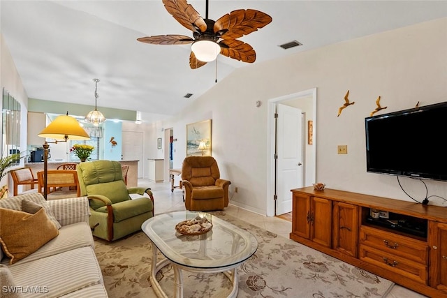 living room featuring lofted ceiling, light tile patterned floors, and ceiling fan with notable chandelier