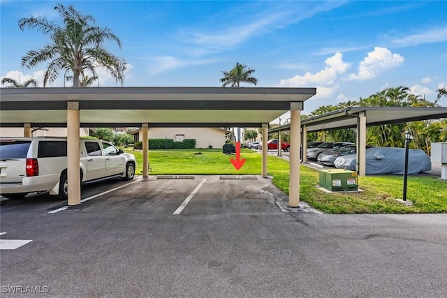 view of vehicle parking featuring a carport and a yard