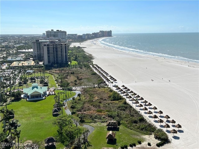 bird's eye view featuring a water view and a beach view