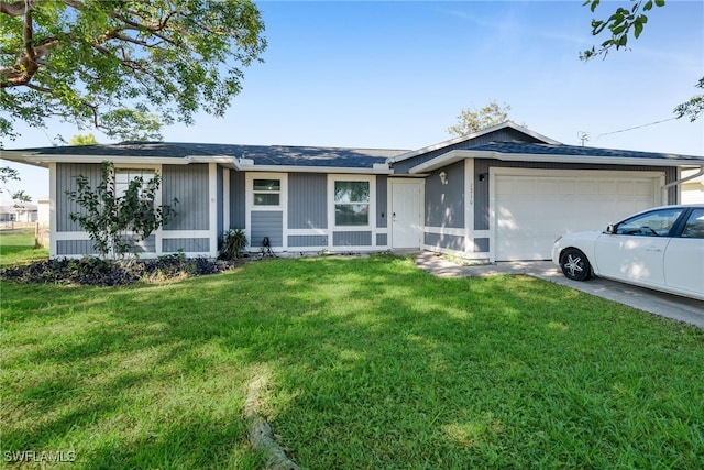 ranch-style home with a garage and a front lawn