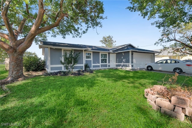 single story home featuring a garage and a front lawn