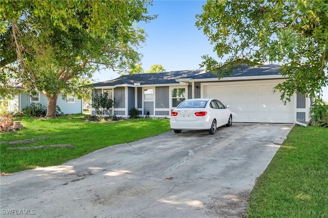 ranch-style home featuring a garage and a front lawn