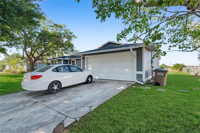 view of front of home with a garage and a front lawn