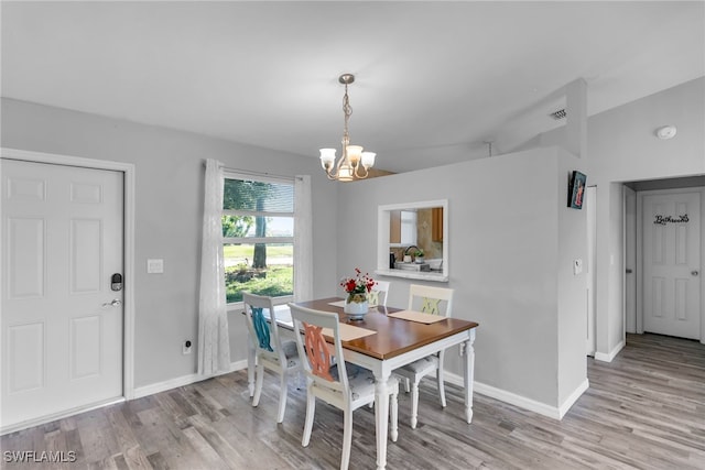 dining area with a chandelier and light wood-type flooring