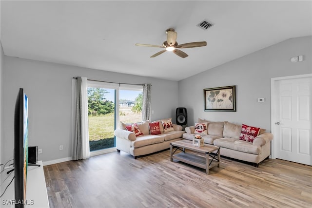 living room featuring light hardwood / wood-style flooring, ceiling fan, and vaulted ceiling