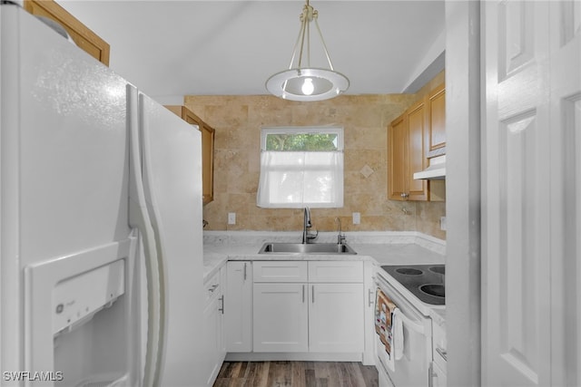 kitchen featuring sink, white appliances, white cabinetry, tile walls, and decorative light fixtures