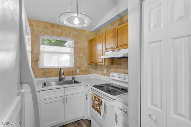 kitchen featuring pendant lighting, light brown cabinetry, white cabinetry, sink, and white range with electric cooktop