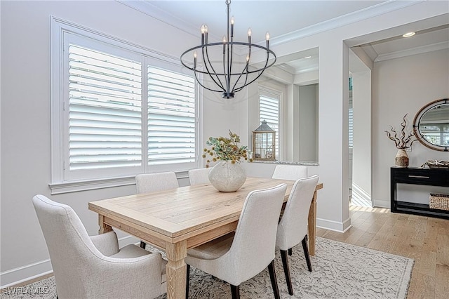 dining area featuring a notable chandelier, crown molding, and light hardwood / wood-style flooring