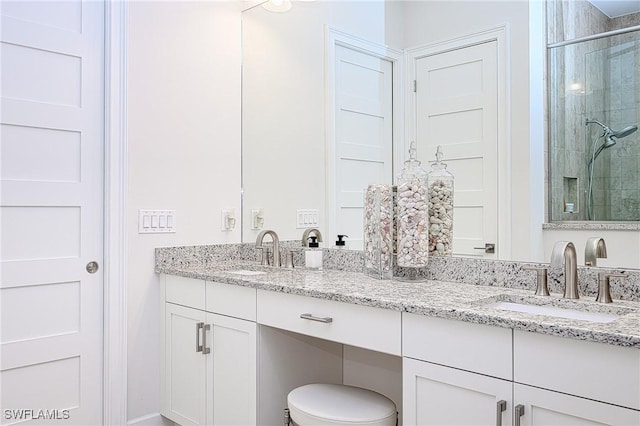 bathroom featuring walk in shower and vanity