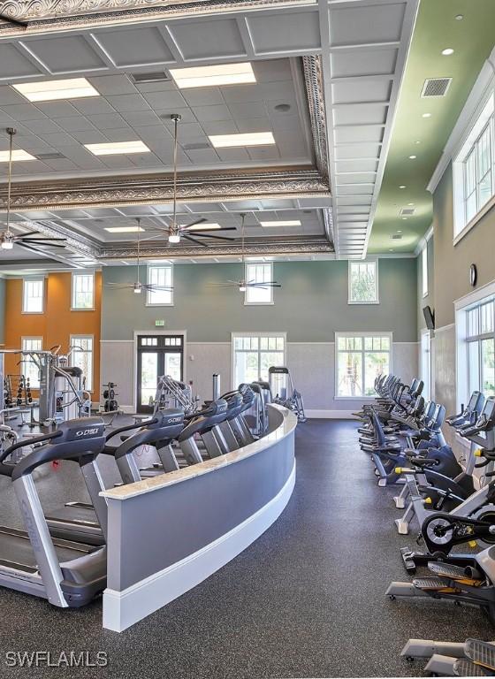 exercise room with a high ceiling