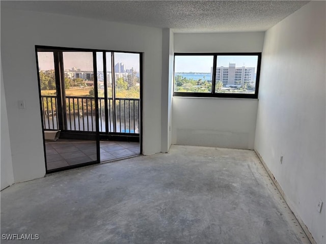 empty room featuring concrete floors and a textured ceiling