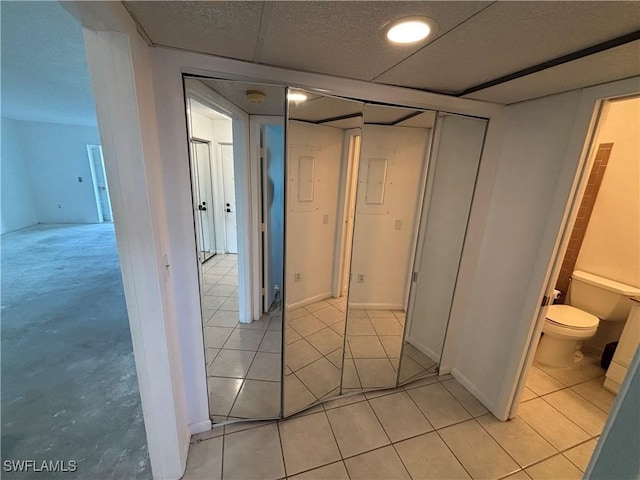 corridor featuring light tile patterned floors