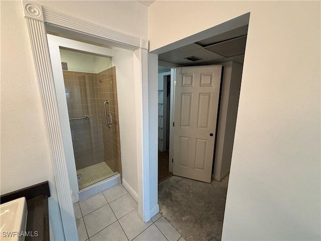 bathroom featuring walk in shower and tile patterned flooring