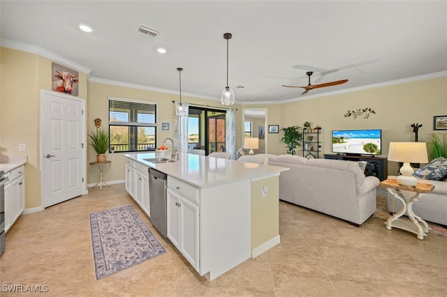 kitchen featuring sink, white cabinetry, hanging light fixtures, appliances with stainless steel finishes, and an island with sink