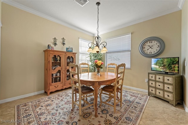 tiled dining space with crown molding and a chandelier