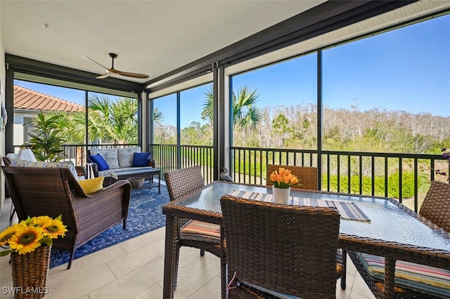 sunroom featuring ceiling fan