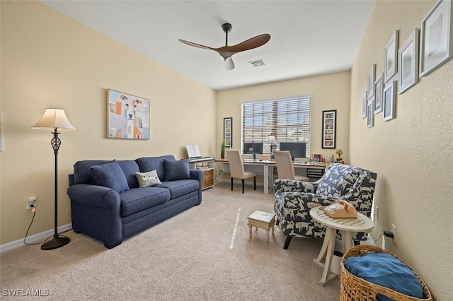 living room featuring light colored carpet and ceiling fan