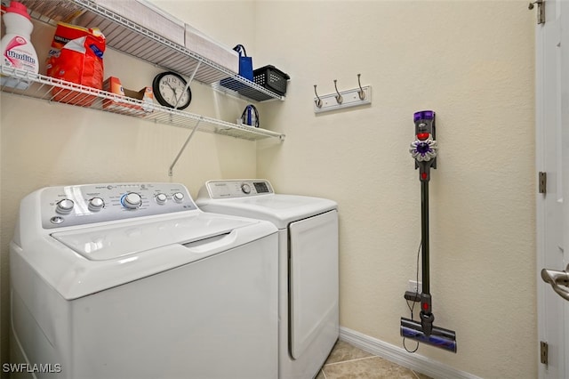 laundry area featuring light tile patterned floors and washing machine and clothes dryer