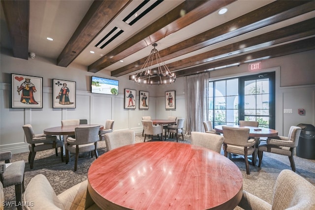 dining room featuring beamed ceiling and a notable chandelier