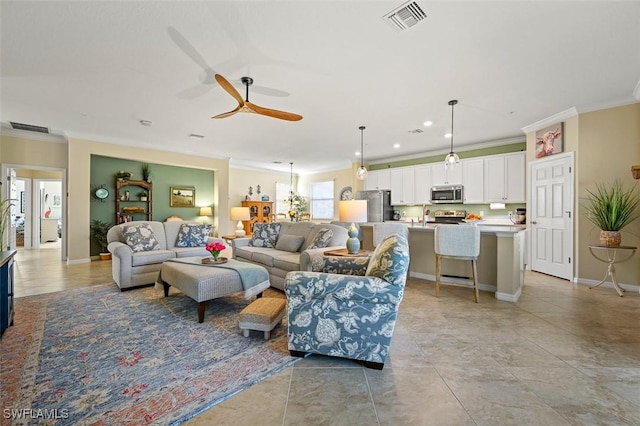 living room with crown molding and ceiling fan