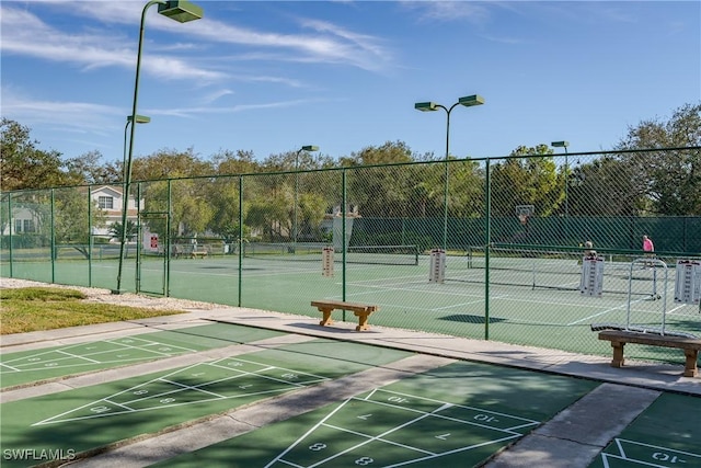 view of property's community with tennis court