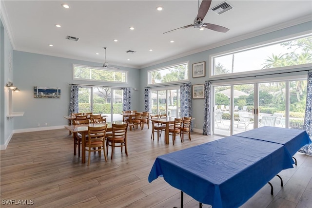 dining room featuring ceiling fan, ornamental molding, and light hardwood / wood-style floors