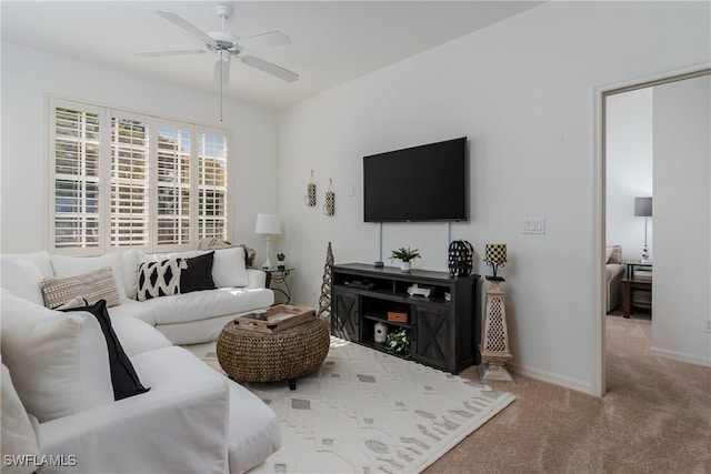 carpeted living room with ceiling fan