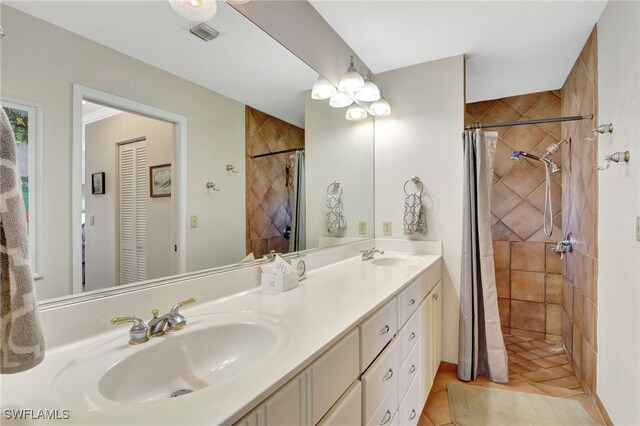 bathroom featuring vanity, tile patterned flooring, and a shower with shower curtain