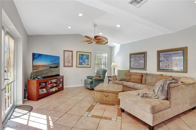 living room featuring light tile patterned flooring, ceiling fan, and vaulted ceiling