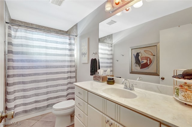 bathroom featuring tile patterned flooring, vanity, walk in shower, and toilet