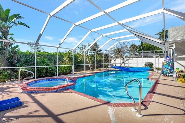 view of swimming pool featuring an in ground hot tub, a patio, and glass enclosure