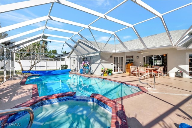 view of pool with a lanai, a patio area, ceiling fan, and french doors