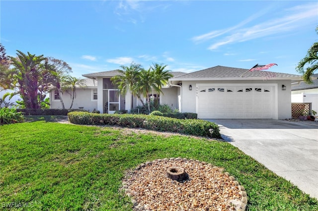 single story home with a garage and a front lawn