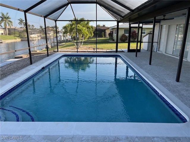 view of swimming pool featuring a water view, glass enclosure, and a patio area