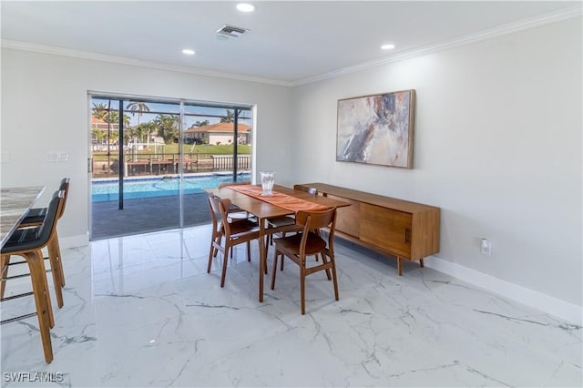 dining space with crown molding