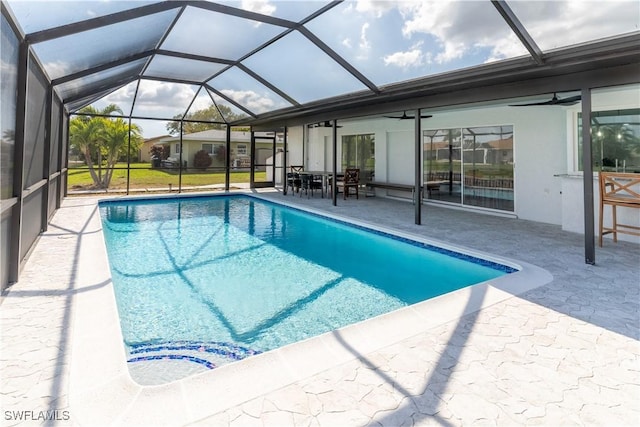 view of swimming pool featuring a patio, a lanai, and ceiling fan