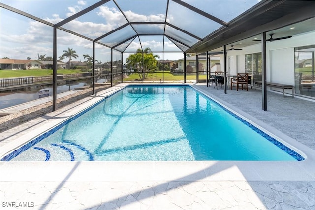 view of pool with a patio area and glass enclosure