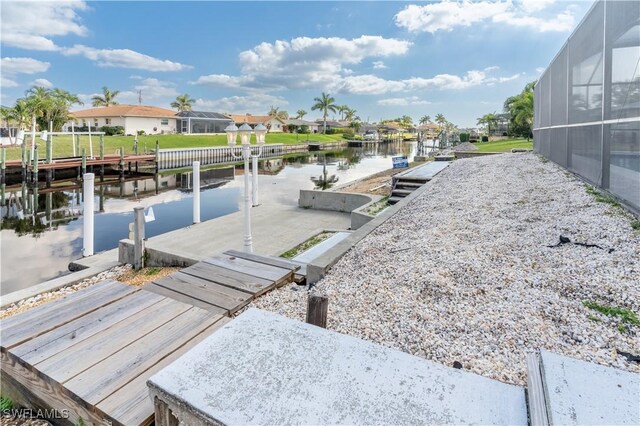 view of dock featuring a water view and a lanai