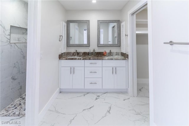 bathroom with vanity and tiled shower