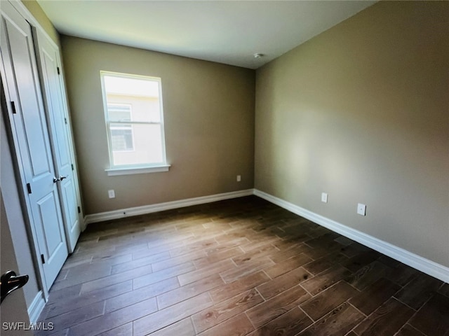 unfurnished bedroom featuring dark hardwood / wood-style floors