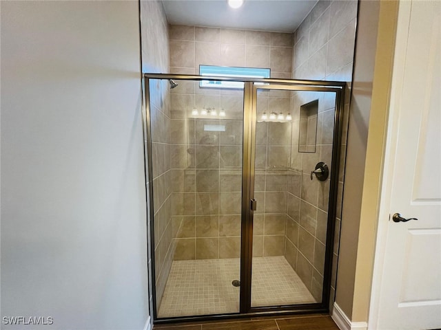 bathroom with a shower with door