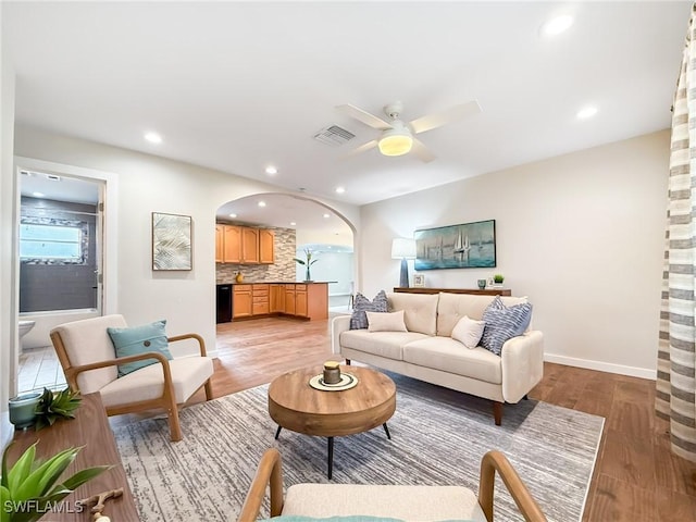 living room featuring light hardwood / wood-style floors and ceiling fan